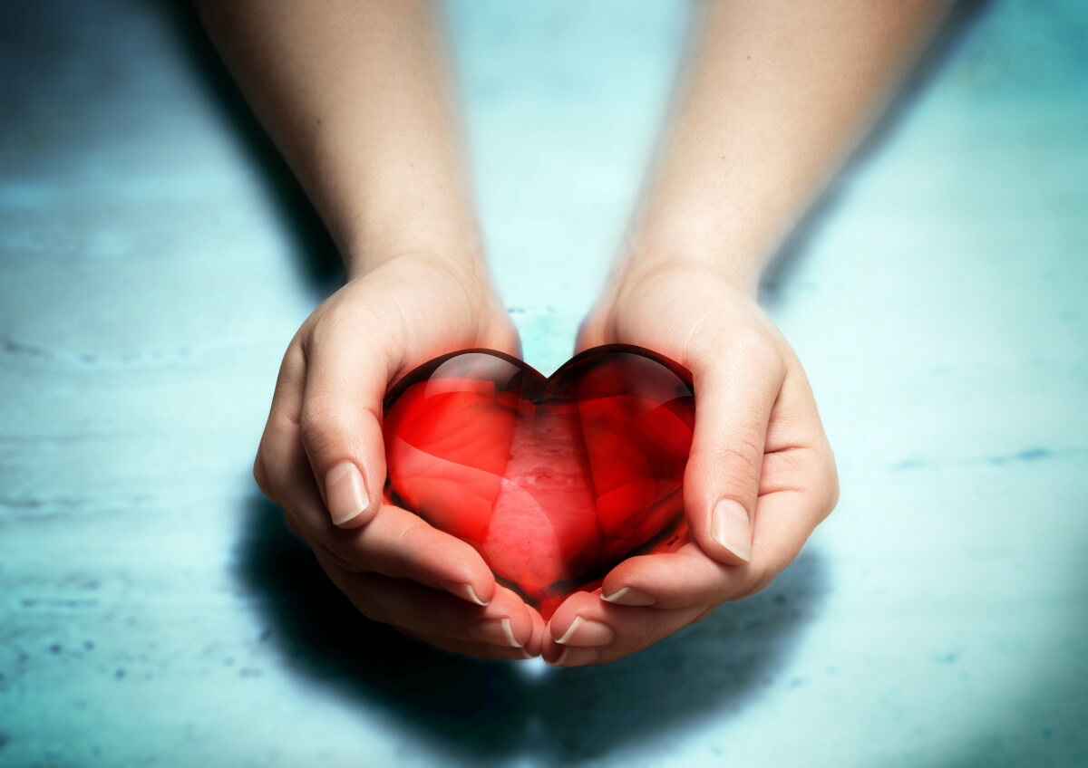 A woman holding a heart in her hands