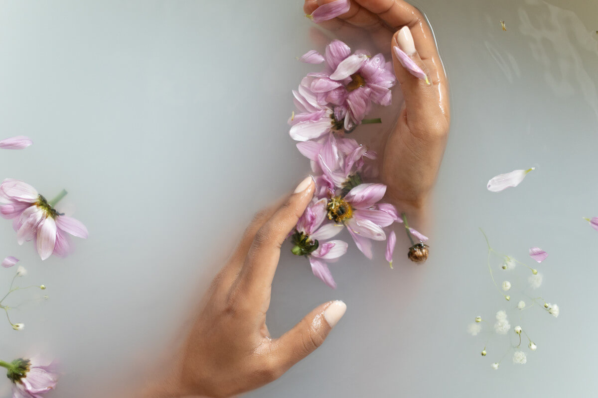 A woman holding flowers in her hands in water
